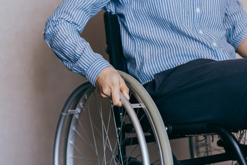 Unrecognizable disabled woman in wheelchair at home. Recovery and healthcare concepts.
