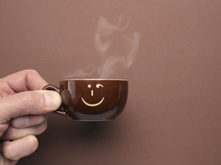 Brown espresso cup with a smiling icon