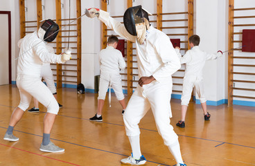 fencers exercising attack movements in duel