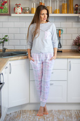 morning young woman in pajama in modern house kitchen, happy and smiling