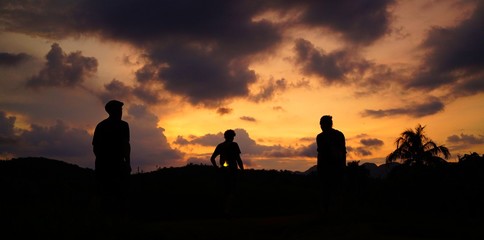 Silhouette of three explorers after sunset