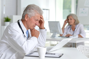 Portrait of male doctor working at desk