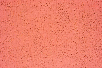 Coral plaster wall. Uneven texture of putty on the wall with copy space