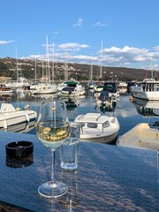 A glass of white wine in the sea harbor restaurant 