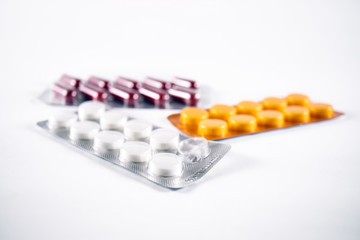 Medicine blister packs, frog eye view on white background