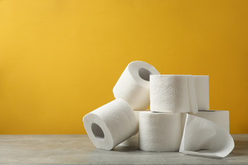 Toilet paper against yellow background, space for text