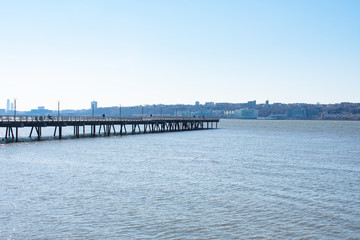 Fototapeta na wymiar Pier I along the Hudson River in Lincoln Square of New York City with a Clear Blue Sky