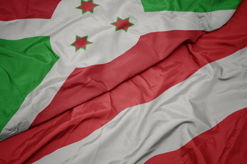 waving colorful flag of austria and national flag of burundi .