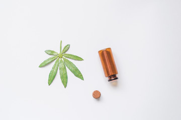 Marijuana in a glass stash jar. Isolated on white. Room for text. Shallow depth of field. Hand made fake Cannabis.