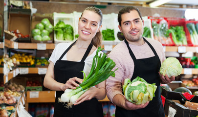 Two sellers offering vegetables