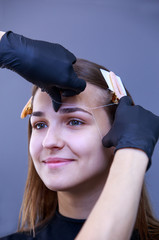 Beautician performs eyebrow alignment procedure