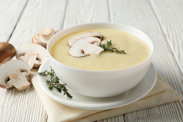 Mushroom cream soup on wooden background, close up