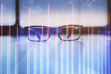 Financial graph hologram with glasses on the table background. Concept of business. Double exposure.