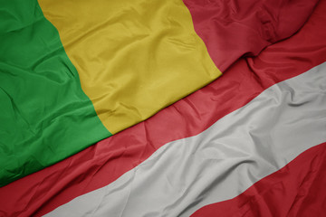 waving colorful flag of austria and national flag of mali.