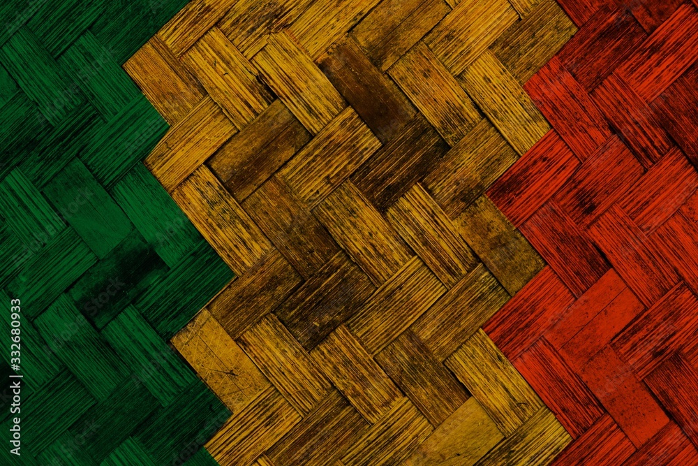 Wall mural green yellow red reggae background on Wickerwork texture