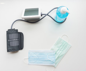 Top view of alcohol gel, mask, digital blood pressure monitor. Corona anti-virus device.protec the spread of corona virus.