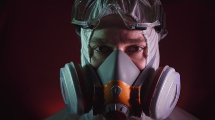 Man in protective costume suit, gas protect medical antibacterial antiviral spray paint mask....