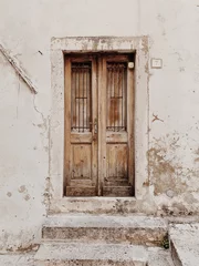 Wall murals Grey  Croatia, 2019. An old vintage beige wooden door. Traditional European architecture. Travel minimal concept.