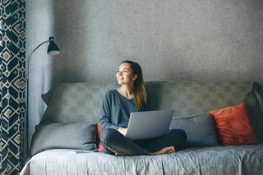 Girl Working On Laptop From Home Or Student Studying From Home Or Freelancer. Or She Is Watching A Video Or Using The Internet