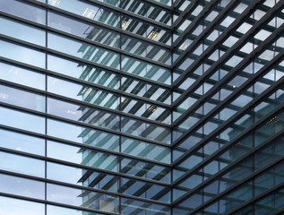 a full frame modern office architecture abstract with geometric shapes and buildings reflected in blue glass windows