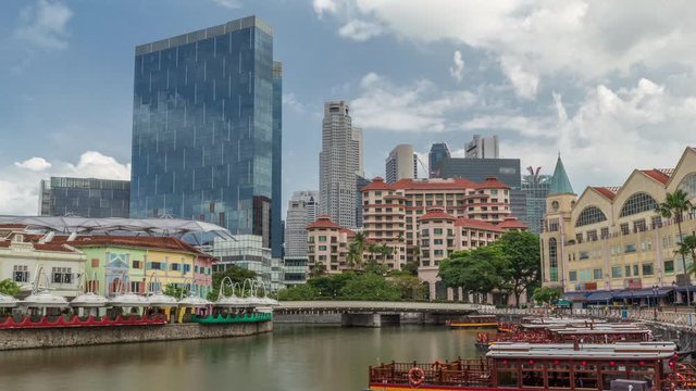 Tourist boats docking at Clarke Quay habour timelapse hyperlapse with downtown skyscrapers. Clarke Quay is a historical riverside quay in Singapore, located within the Singapore River Planning Area.