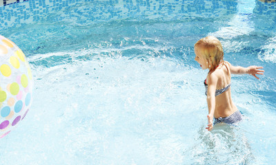 Little girl having fun time in the Swimming pool, Summer time, Vacation