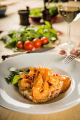 fried shrimps with risotto on white plate