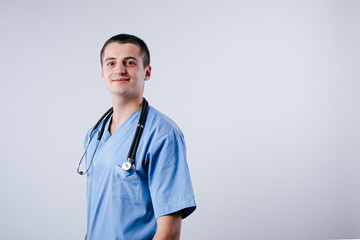 Portrait of happy smiling male doctor intern isolated on white background