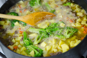 Vegetable stew with meat boils in a large pot. Close up. Healthy diet.