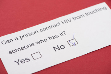  paper card with HIV questionnaire on red background