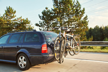 car is transporting bicycles on rack. bikes on the trunk. - 332689988