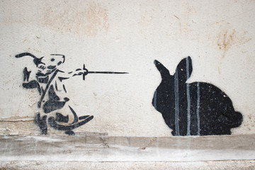 Inspirational stencil rat fighting a cat on a wall