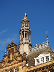 ornate stone towers and domes on the roof of leeds city market a historical building in west yorkshire england