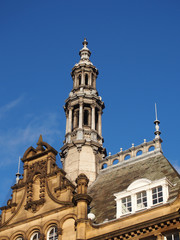 Fototapeta na wymiar ornate stone towers and domes on the roof of leeds city market a historical building in west yorkshire england