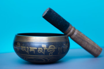 Tibetan singing bowl on a blue background 
