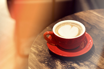 cappuccino cup on the brown wooden table