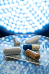 Color medicine pills on blue laboratory table