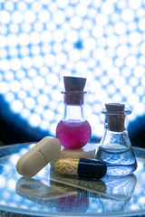 Test tubes and medicine pills on blue laboratory background