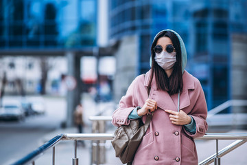 Female in medical mask outdoors in the empty city. Health protection and prevention of virus outbreak, coronavirus, COVID-19, epidemic, pandemic, infectious diseases, quarantine concept.