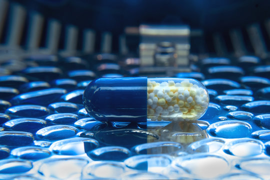 Color medicine pills on blue laboratory table