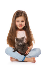 Little cute girl with a gray british kitten