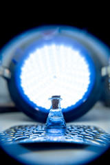 Test tube with color solution on blue laboratory background