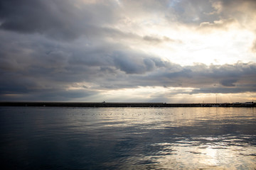 Obraz premium Clouds on dock bay marine during sunset