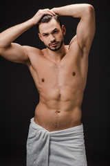 handsome sexy muscular man in towel isolated on black