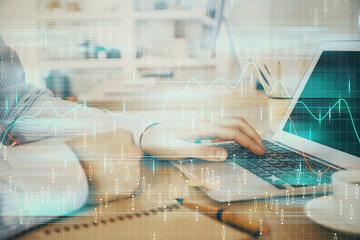 Multi exposure of stock market chart with man working on computer on background. Concept of financial analysis.