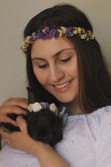  Portrait of young girl in floral wreath with Easter bunny
