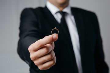 Businessman proposes with wedding ring in hand