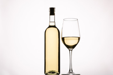 Bottle of delicious wine and glass on white background