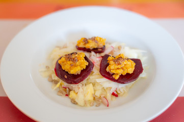 delicious salad on a white plate  with kohlrabi, beetroot, lentils and grains