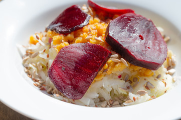 delicious salad on a white plate  with kohlrabi, beetroot, lentils and grains
